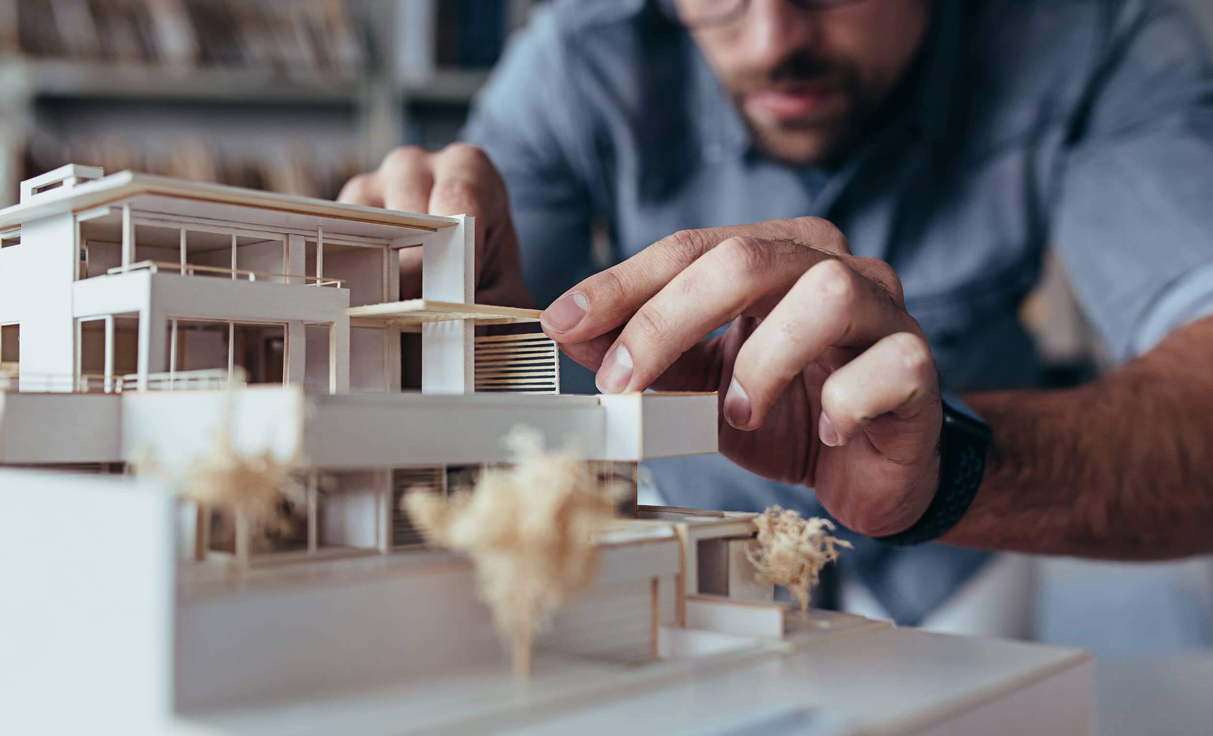 man fixing a building mock up